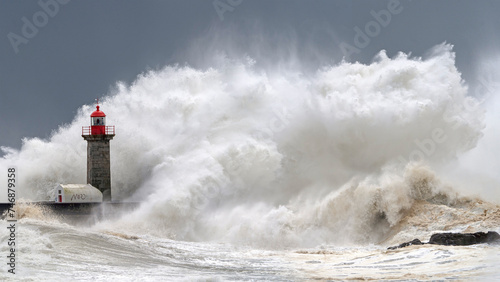 Lighthouse and oceanic wave during storm © Eduardo