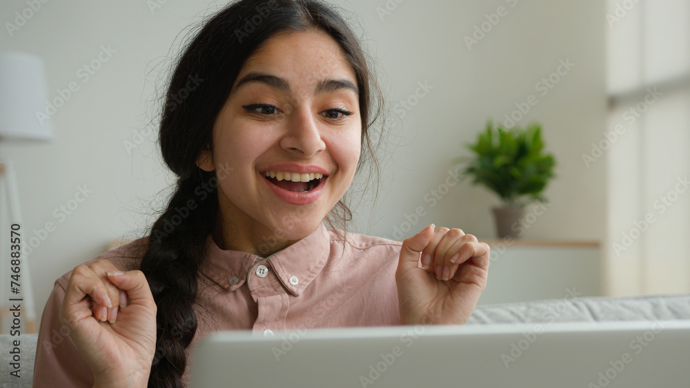 Happy shocked arabian woman girl student looking at laptop screen at ...