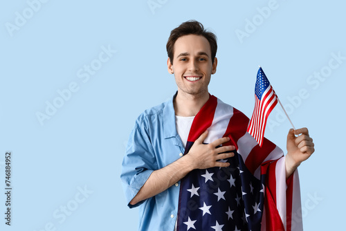 Young man with USA flags on...