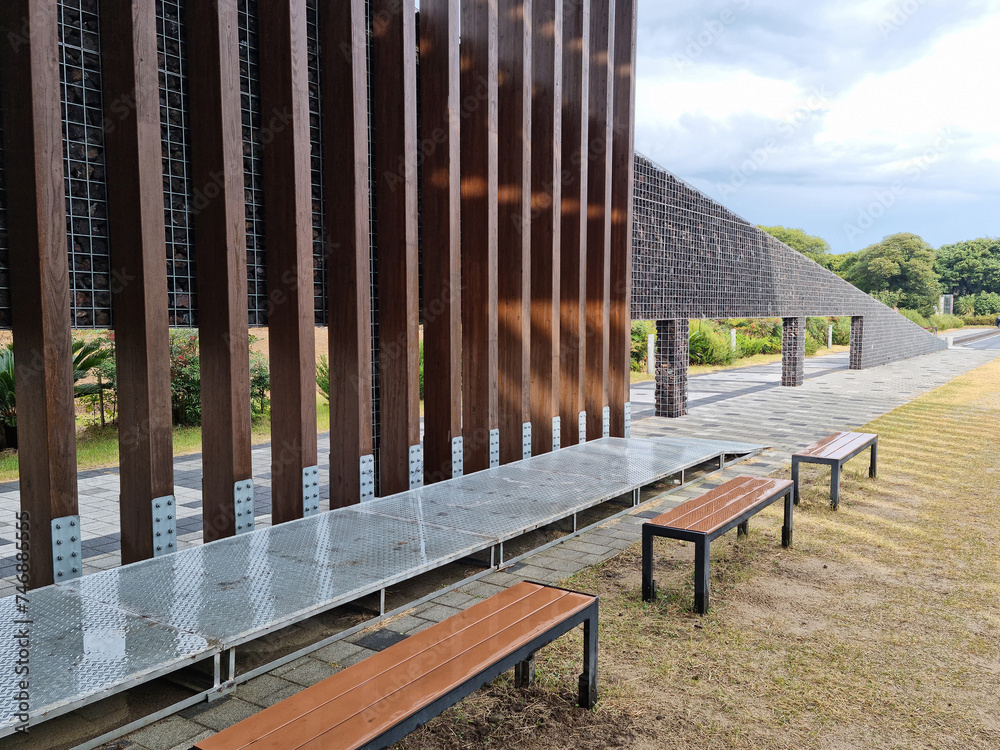 An outdoor park with wooden pillars and benches. An outdoor park with wooden pillars and benches.