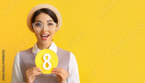 Surprised woman with paper figure 8 on yellow background with space for text. International Women's Day	
 photo