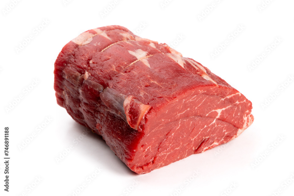 A center cut piece of beef tenderloin with trussing strings isolated on white