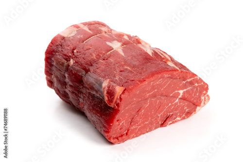 A center cut piece of beef tenderloin with trussing strings isolated on white