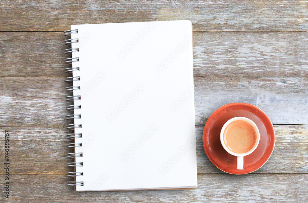 Top view with coffee cup and notebooks on wood table in office Top view with coffee cup and notebooks on wood table in office
