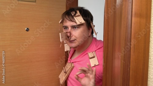 Loser father raising children, victim of prank, opens door, enraged holds back emotion, hand gesture ok, everything is fine Open door to curious neighbors, family fun, children prank Parental patience