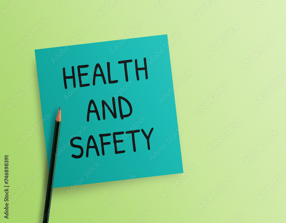 Writing note showing Health and Safety on green background. Writing note showing Health and Safety on green background.