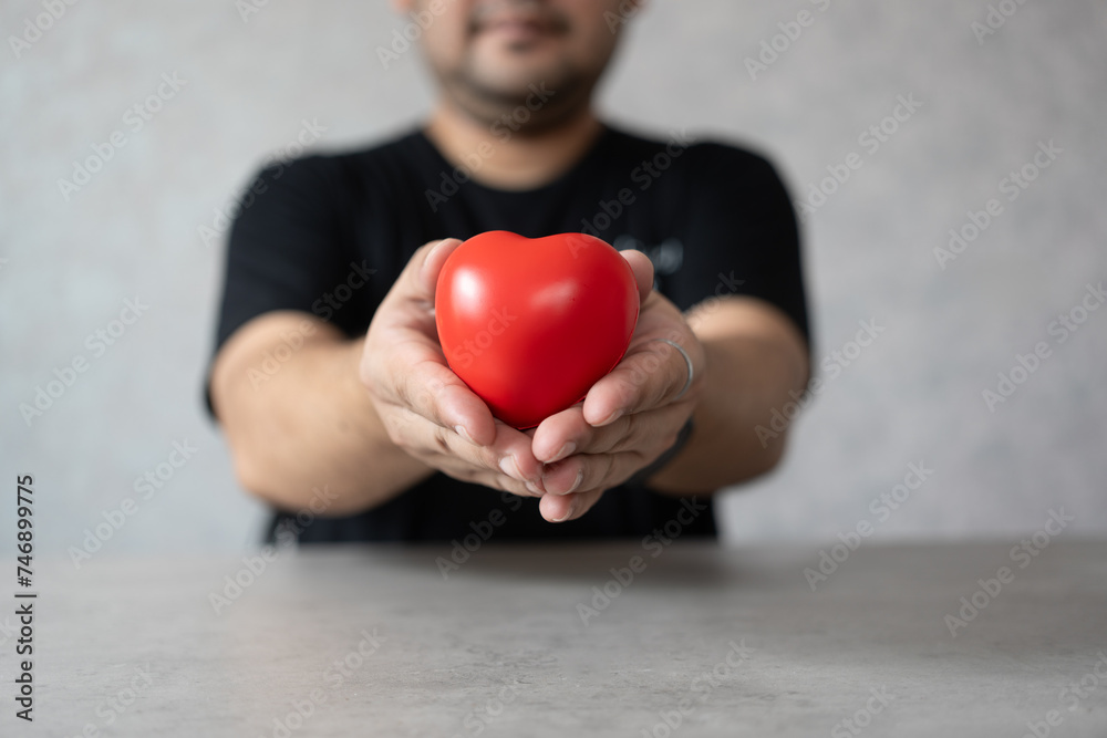 Hand give red heart for love. Man holding heart