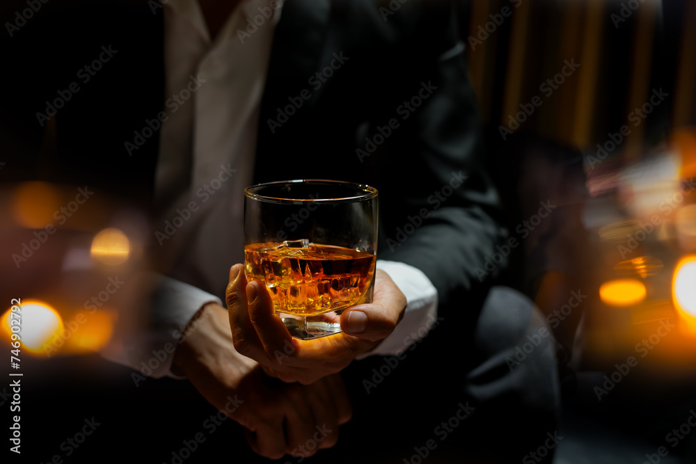 businessmen holding a glass of whiskey businessmen holding a glass of whiskey