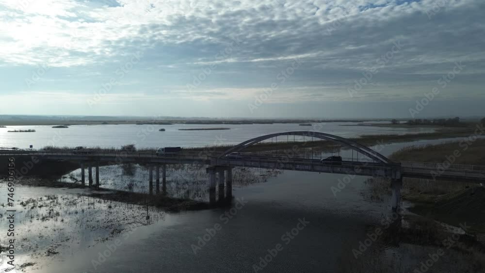 road bridge car river overflow flood meadow sunny day aerial boom dolly road bridge car river overflow flood meadow sunny day aerial boom dolly