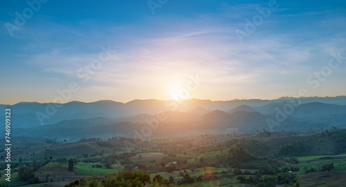 Scenic mountain landscape and bright sunrise or sunset sky over the horizon. Natural skyscape background