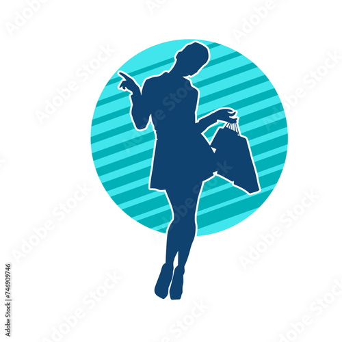 Silhouette of a slim young woman carrying shopping bags.