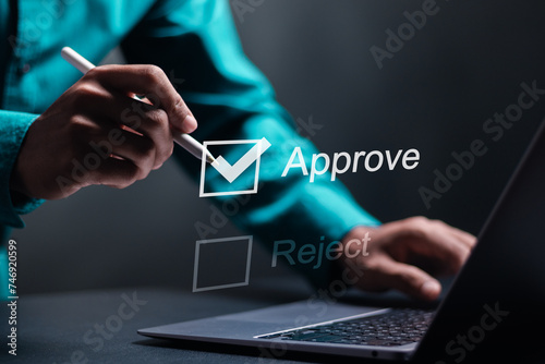Option to approve or reject. Businessman tick a checkbox with the text approve. Deciding between approve or rejecting for business project. photo