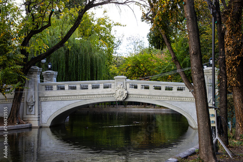 Bridge over the lake Cismigiu in Cismigiu garden, a famouis park in the center of Bucharest, Romania photo