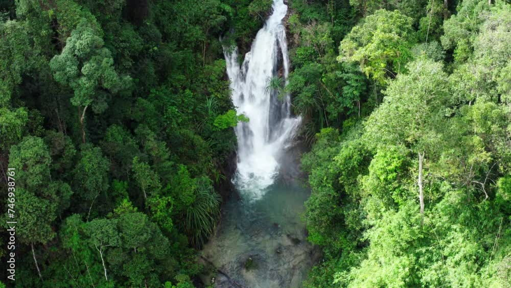 Waterfall in tropical rainforest jungle, falling water hitting water surface,Thailand. Aerial drone shot, Waterfall in tropical rainforest jungle, falling water hitting water surface,Thailand. Aerial drone shot,