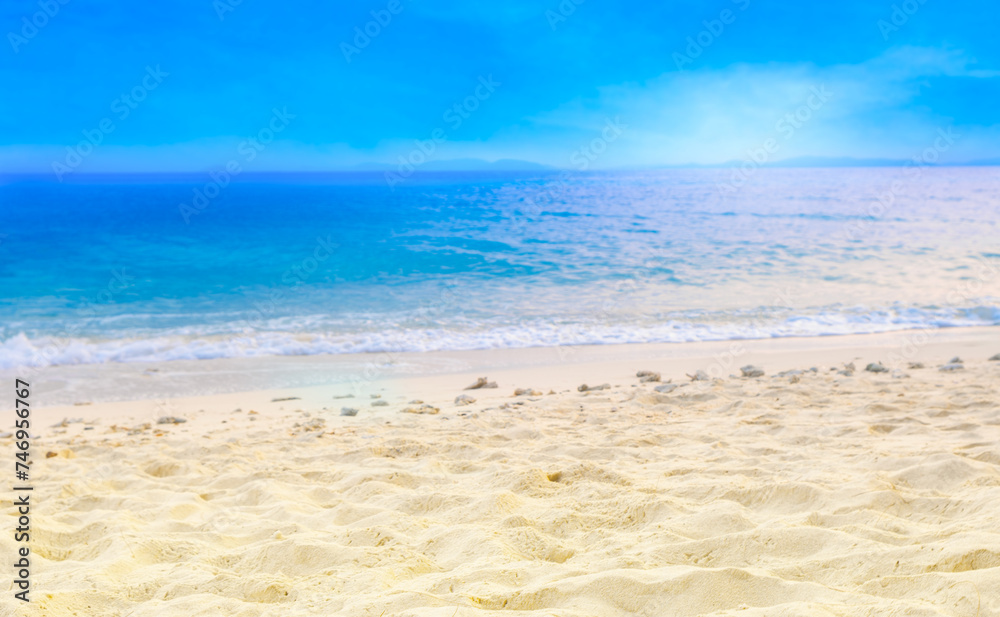 Beach and blue ocean waves for summer vacation concept. Nature of the beach and sea sunny summer The sky is clear. Sandy beach and sparkling sea water