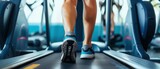 Closeup leg of cardio workout Low section of a woman running on a treadmill in a fitness center