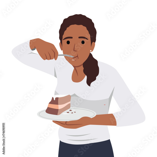 Hungry young woman eating cake suffer from eating disorder. Happy girl enjoy chocolate dessert. Guilty pleasure