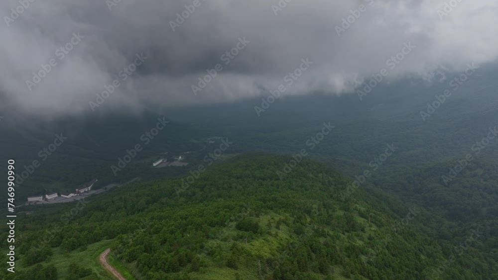 Aerial view through clouds, high in the gloomy Joshinetsu National Park in Japan