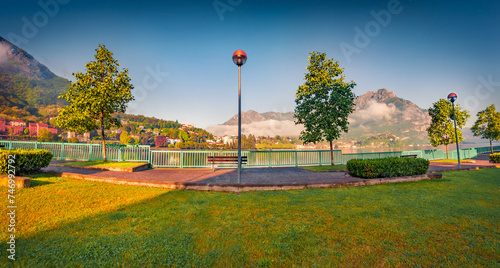 Fototapeta Naklejka Na Ścianę i Meble -  Panoramic summer view of public park of Lecco town with Resegone peak on background, Italy, Europe. Colorful morning scene of Como lake in Italian Alps. Traveling concept background.
