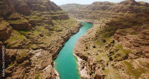 Mountain in background in hazy day in nature the green fresh vivid color of river in the adventure canyon dezful mud rock clay cliff in outdoor hiking travel natural view of wild country in Iran photo