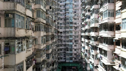 Monster building Montane Mansion in Quarry Bay Hong Kong, consists of several tightly packed buildings with window grilles, canopies, and air-conditioning ,an old residential units are well-proportion photo