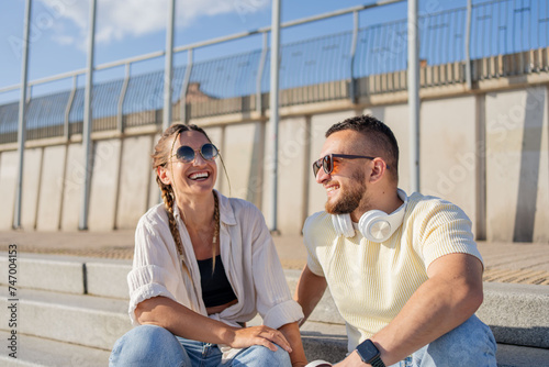 Friendship, flirting and couple with sunglasses in city at street laughing. Love, friends and romance, urban dating and freedom.