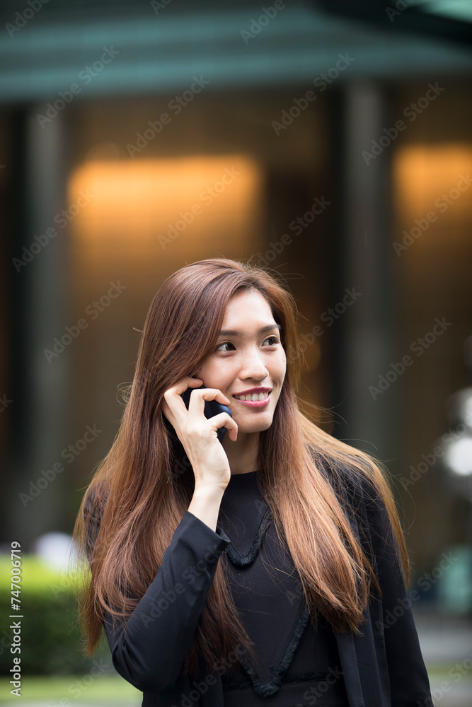 Asian businesswoman using her smart phone. Asian businesswoman using her smart phone.