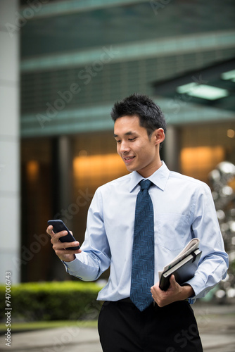 Photography Chinese business man using his mobile phone.