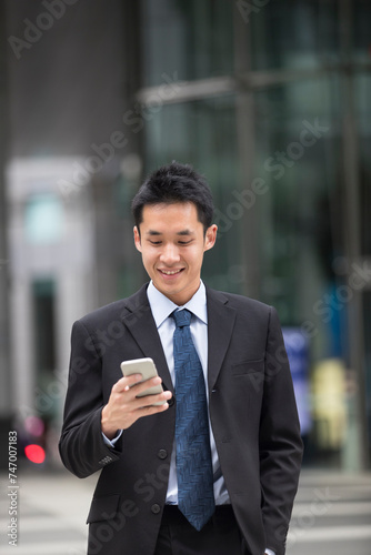 Chinese business man using his mobile phone.