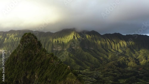 Aerial tracking shot of unique geography and mountain formations, sunset in Hawaii photo