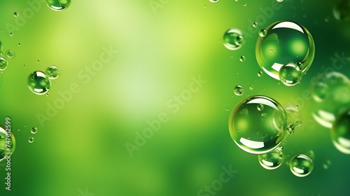 Green oil drops in water. Bubbles of different sizes on green abstract background