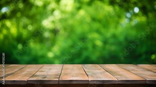 Wooden table with green bokeh background for product display or food photography © Ameer