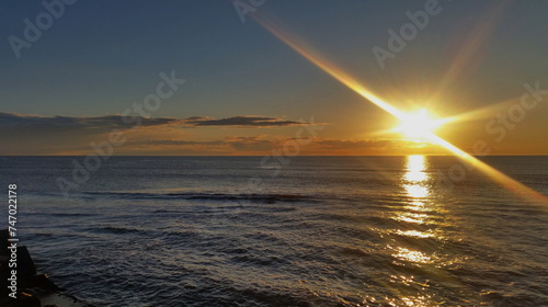 Colorful sunset on the shores of the Barents Sea. Varandey, Arctic, Russia.