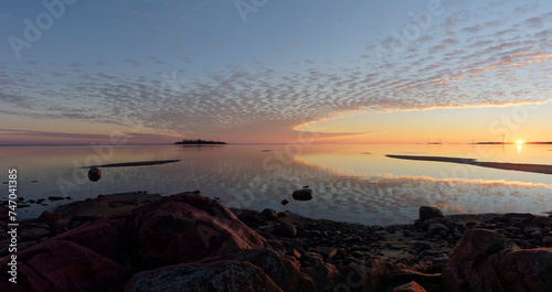 Tableau sur toile Colorful sunset by the calm sea with moody sky and beautiful clouds