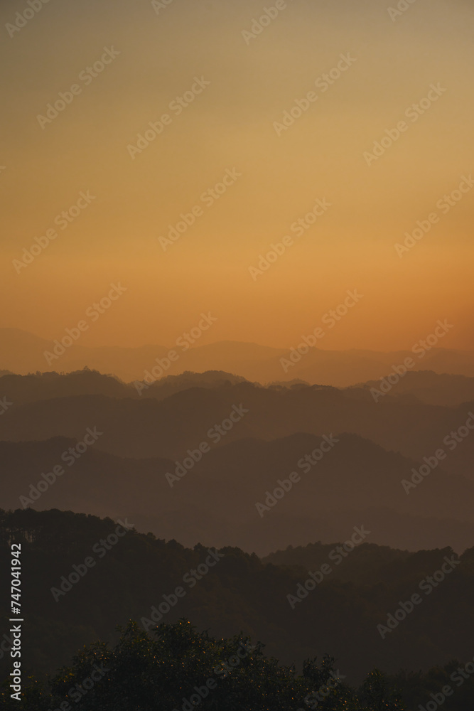 landscape and travel concept with sunset and twilight sky with layer of mountain