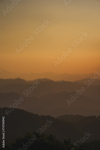 landscape and travel concept with sunset and twilight sky with layer of mountain