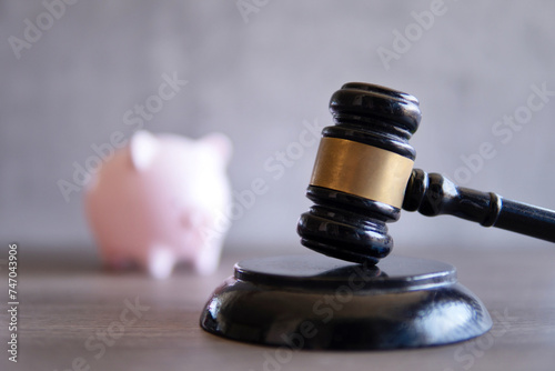 Closeup image of judge gavel and piggy bank. Bankruptcy, insolvency and financial concept.