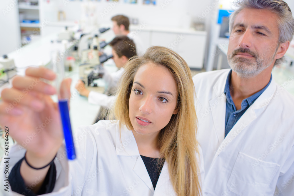 student and teacher with test tube