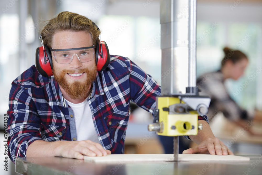 smiling joiner using drilling machine to make drawer at workshop smiling joiner using drilling machine to make drawer at workshop