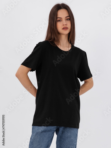 mockup of a black loose-fitting t-shirt on a young beautiful girl