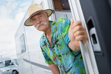 senior man standing at a campground