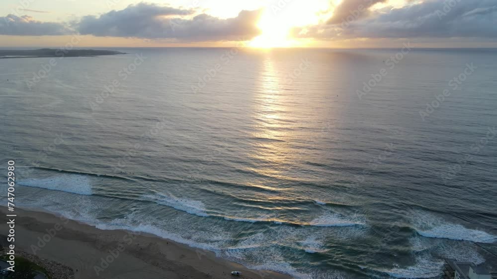 Aerial drone pullback reverse view of Cronulla in the Sutherland Shire, South Sydney, NSW Australia during an early morning sunrise in February 2024   