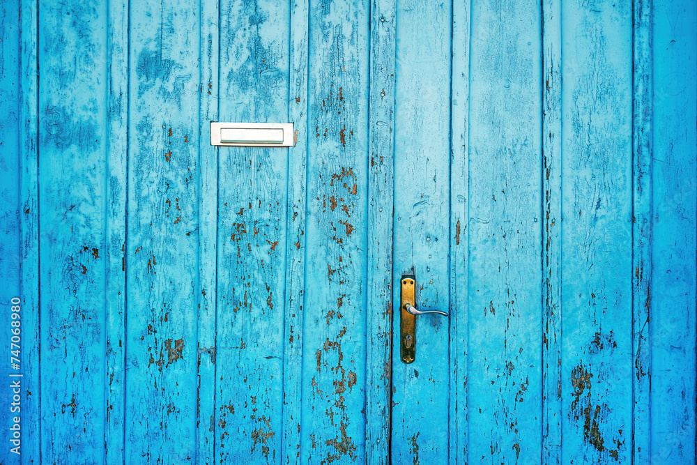 Old blue worn wooden door with letter box Old blue worn wooden door with letter box