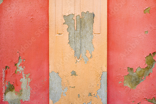 Worn cement wall facade with flaking paint color as background