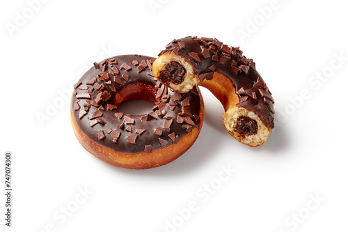 Fluffy freshly baked chocolate donuts with filling on white