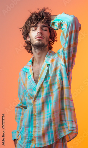 Carefree and casual wake-up style of a young man against a gradient background, reflecting a relaxed and easygoing morning vibe with a touch of contemporary flair.