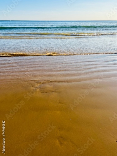 Blue ocean horizon, sandy beach, seascape background