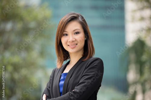 Asian businesswoman standing outside.