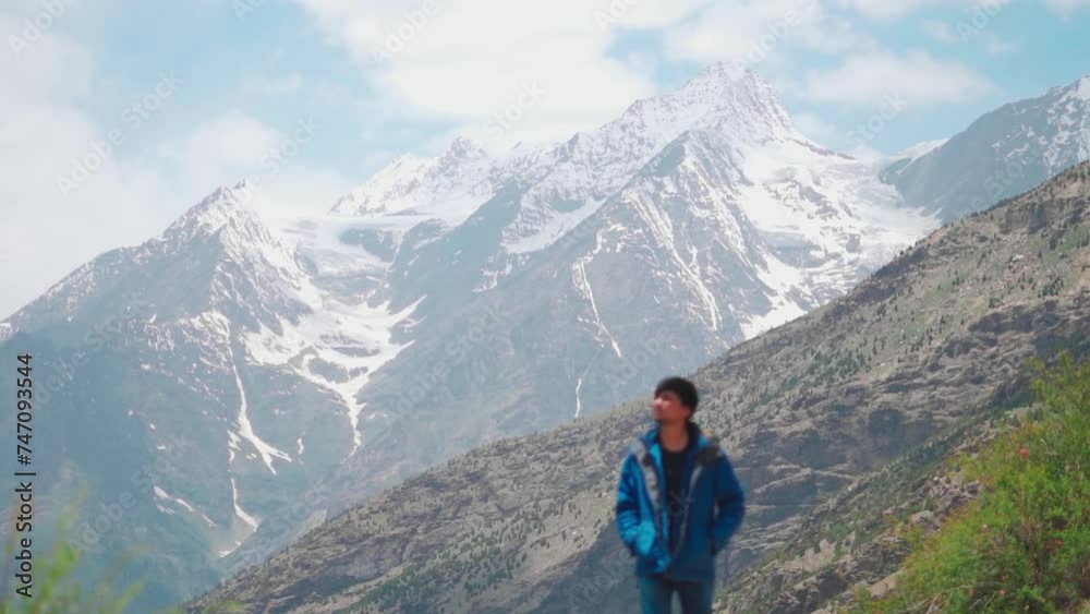 Defocused Hiker man hiking on mountain during summer season at Lahaul, Himachal Pradesh, India. Man walking alone against snow capped himalaya mountains. Travel Concept. Summer adventure journey Defocused Hiker man hiking on mountain during summer season at Lahaul, Himachal Pradesh, India. Man walking alone against snow capped himalaya mountains. Travel Concept. Summer adventure journey