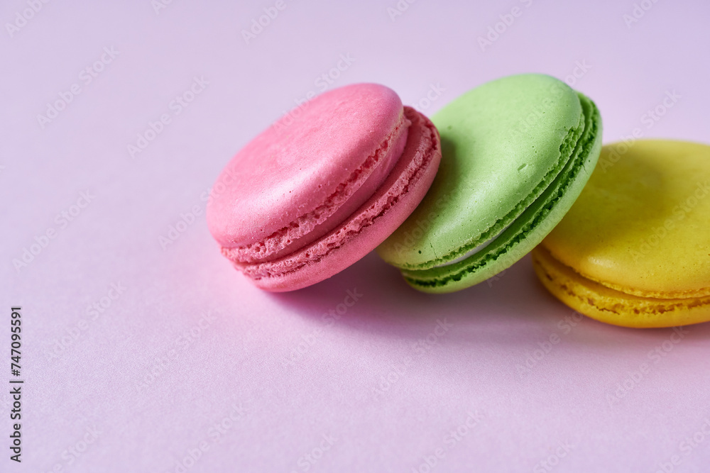Colorful macaroons on a pink background. Close up. Colorful macaroons on a pink background. Close up.